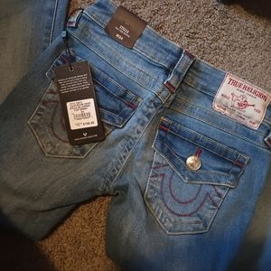 Female adidas high tops and female True Religion skinny jeans